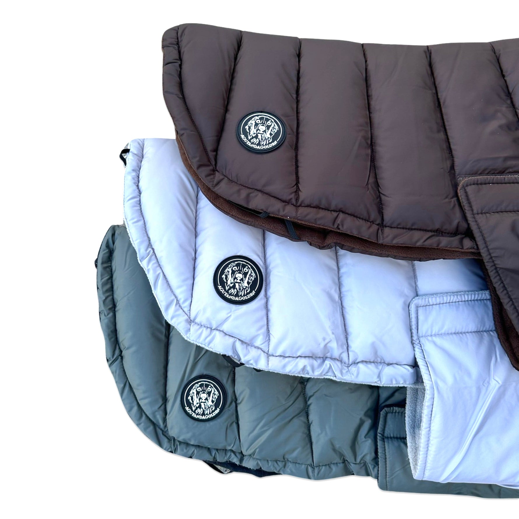 Two dog puffer jackets, one brown and one gray, with a brand logo on a white background.