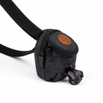 Black dog waste bag dispenser with a brown patch on a white background