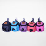 Five colorful dog waste bag holders in a row on a white background.