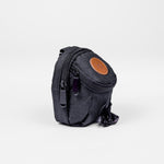 Small dark gray bag with a brown patch on a white background
